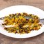 Сибас, запеченный с кедровыми орешками и изюмом