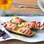 Запечённые баклажаны с сосисками и перепелиными яйцами
